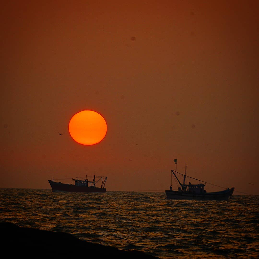 Two Boats beneath the Ember Sun